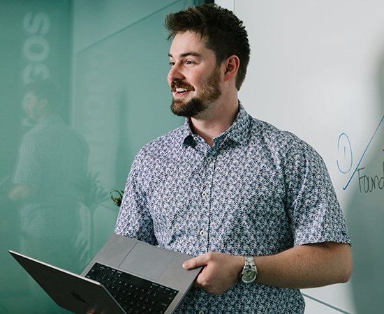Kason holding a laptop